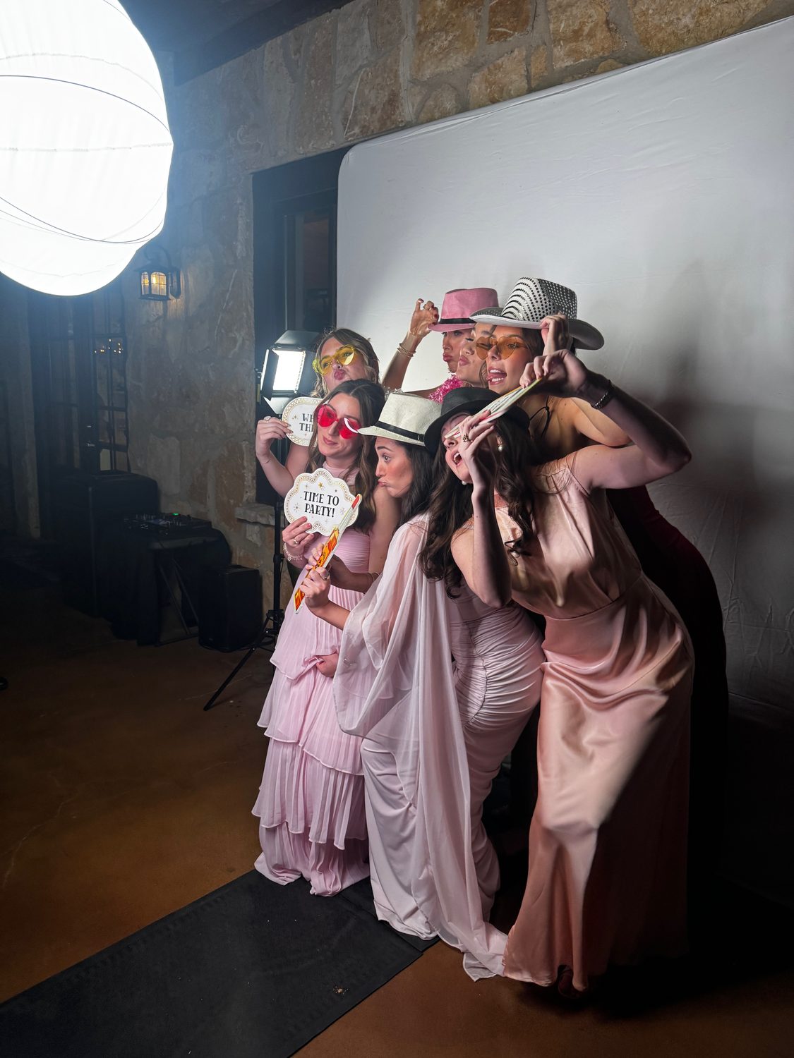 Guests posing together in the photo booth with props