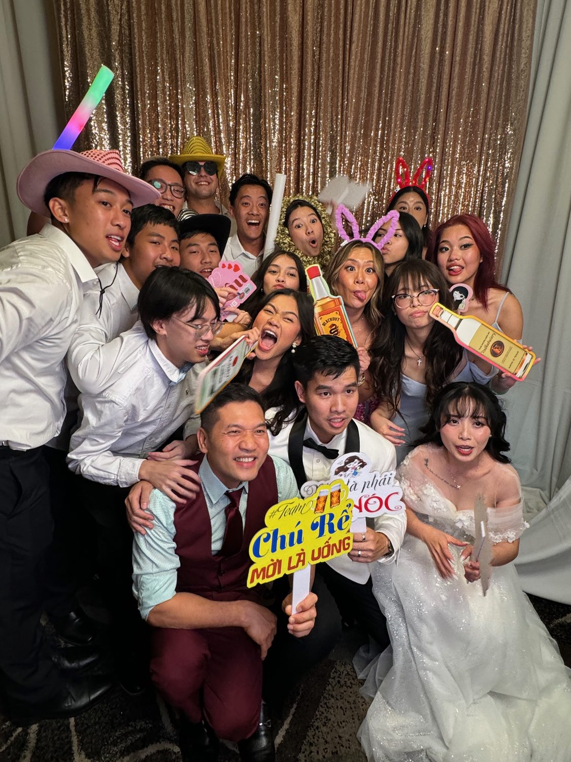 Guests packed into a Dynamic Celebrations photo booth with props