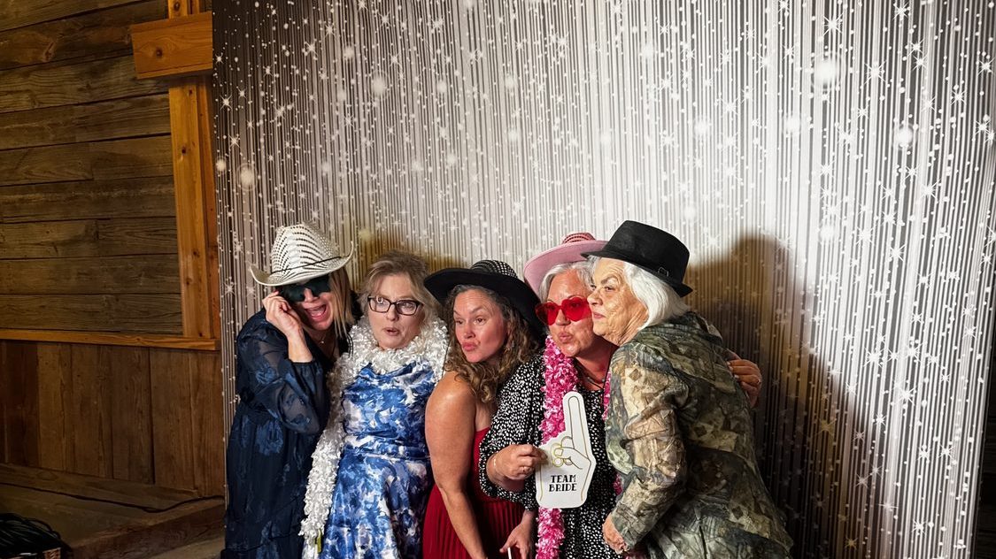 Guests at the Glam photo booth with studio lighting
