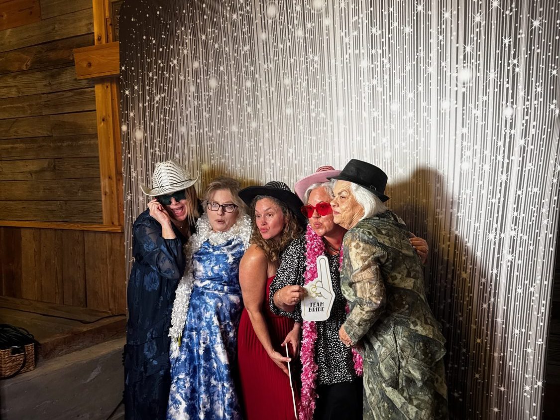 Guests at the Glam photo booth with studio lighting