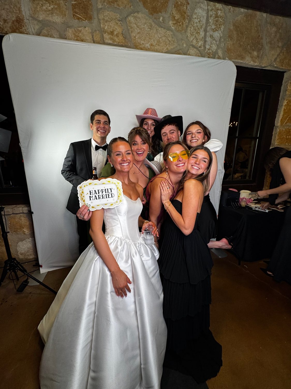 Guests at the Glam photo booth with studio lighting and props