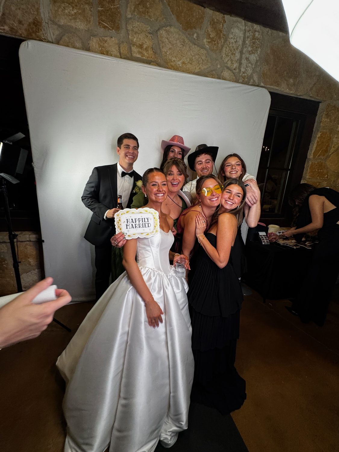 A bride and her wedding party in the photo booth