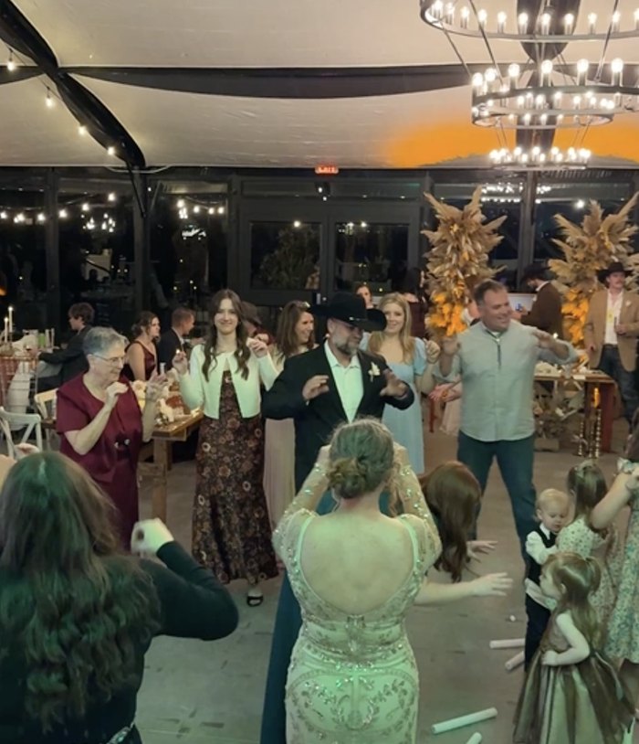 Guests dancing under the pavilion chandeliers at a Dynamic Celebrations wedding at The Delanie
