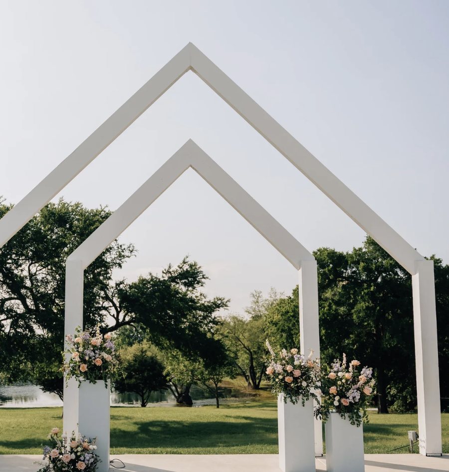 The double arch ceremony site at The Delanie, styled with florals