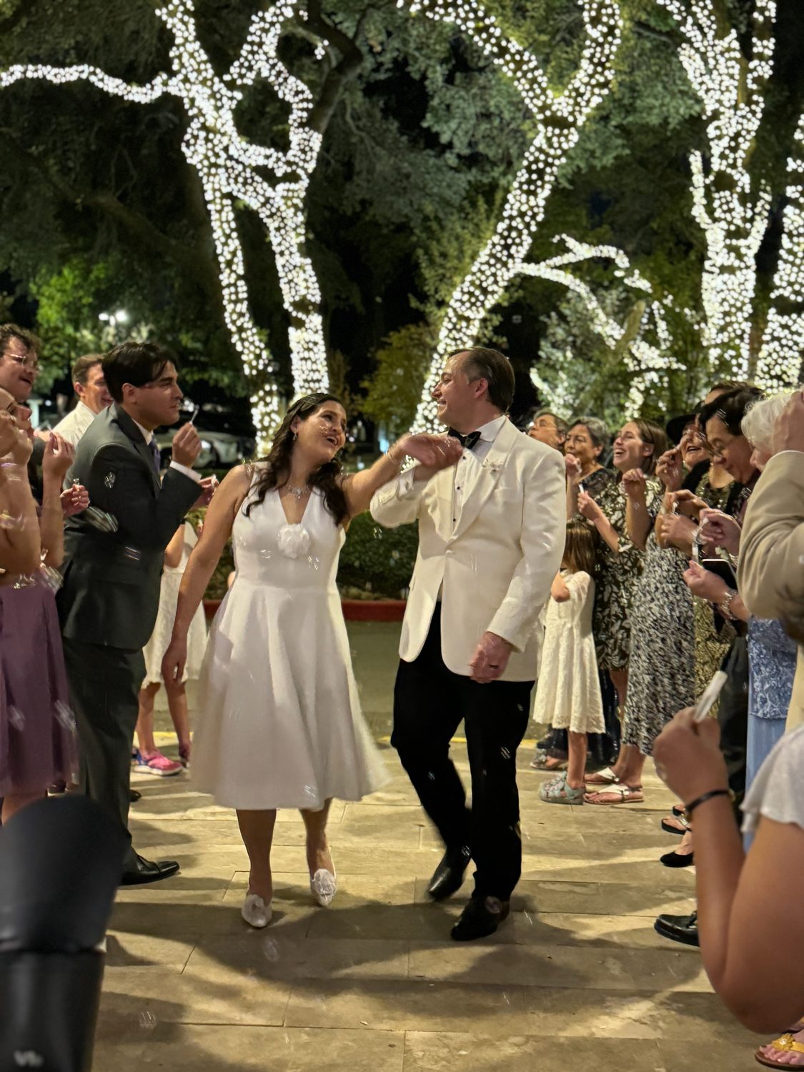 The couple dancing surrounded by their guests