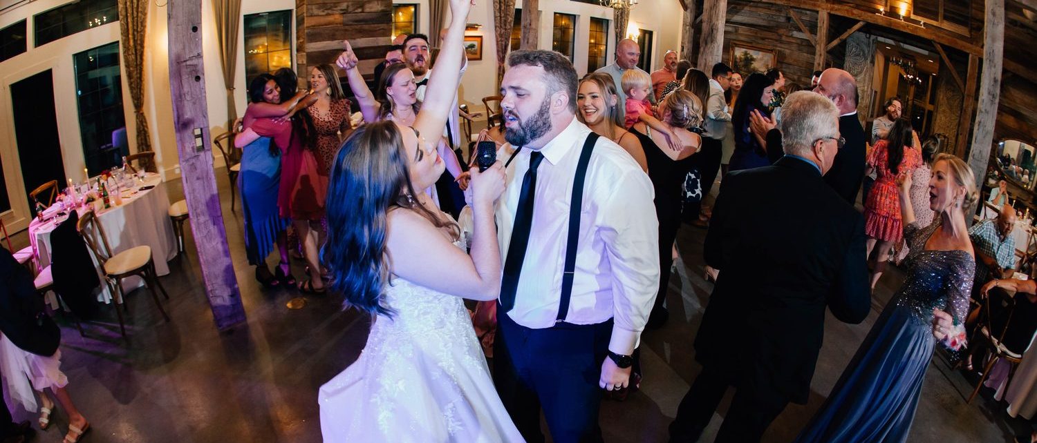 The couple surrounded by guests on the dance floor