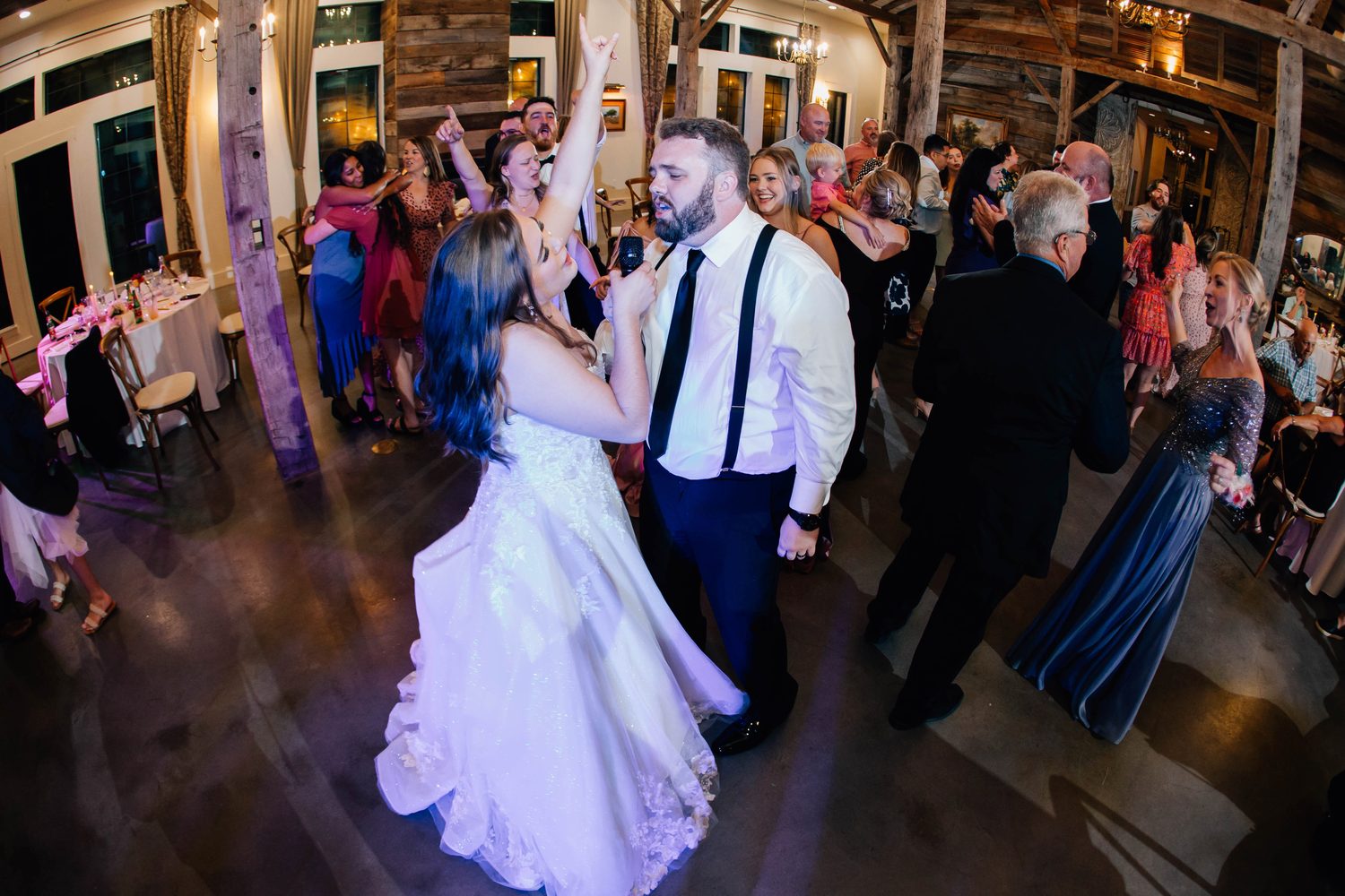 The couple surrounded by guests on the dance floor