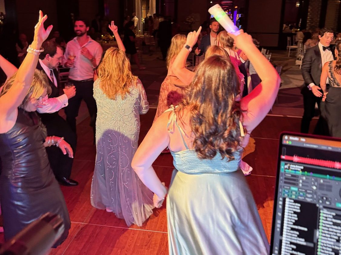 Guests dancing under coloured uplighting