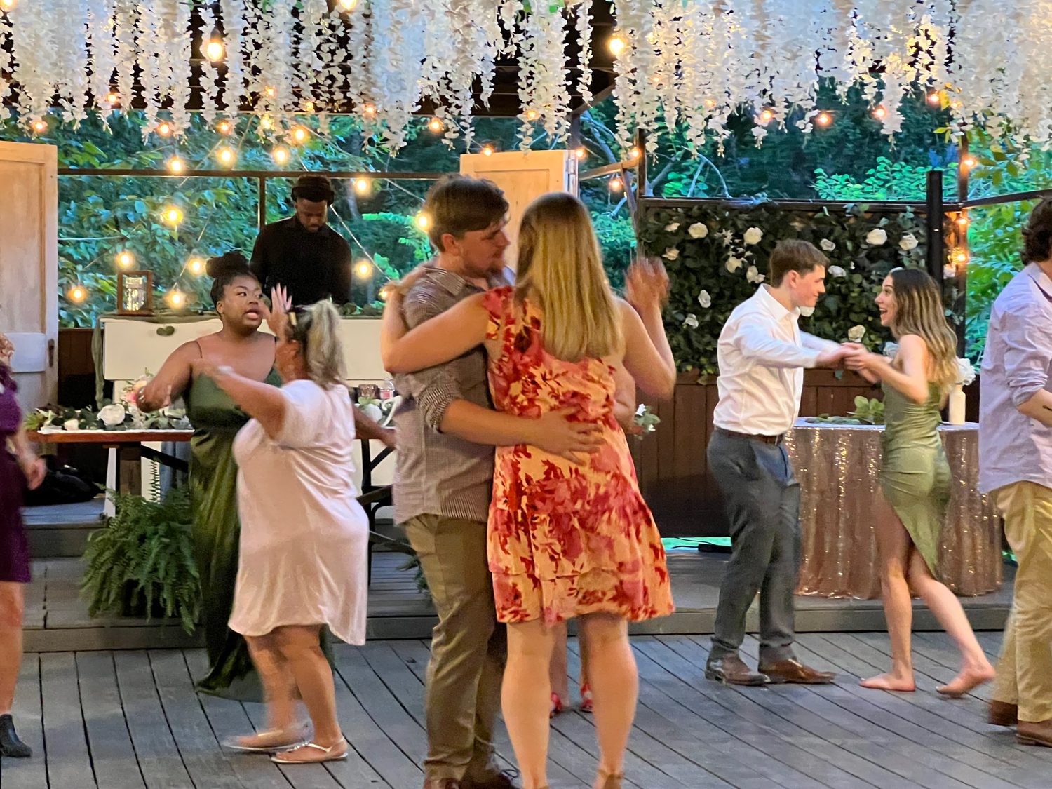 Guests dancing under string lights