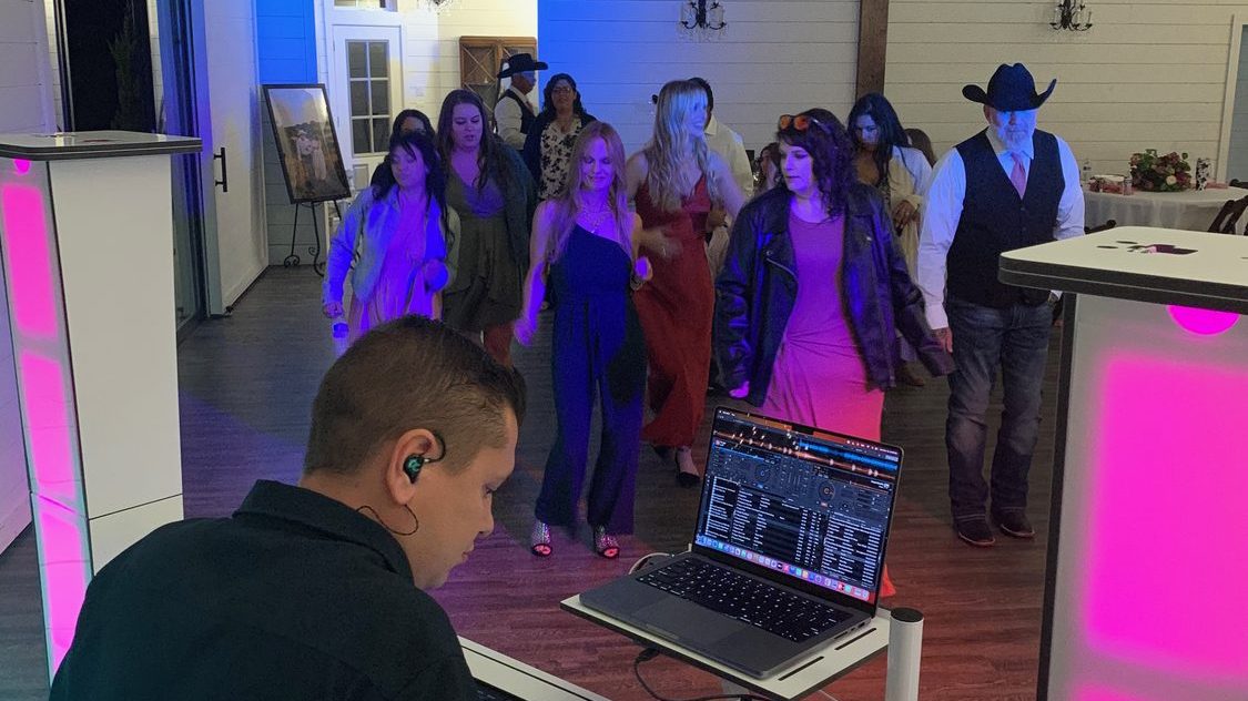 The Dynamic Celebrations DJ and MC working the booth