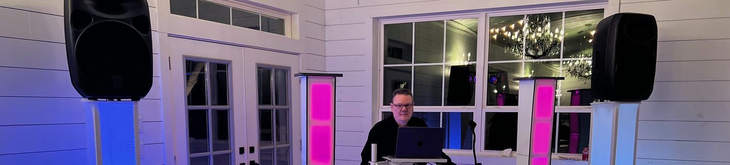 The DJ booth lit in blue and pink