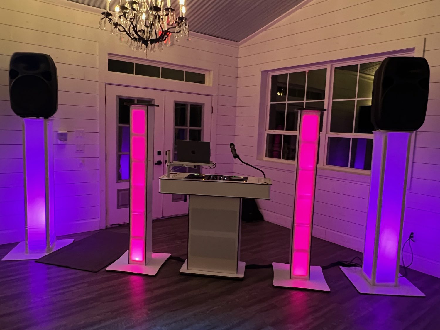 The DJ booth with LED lighting towers