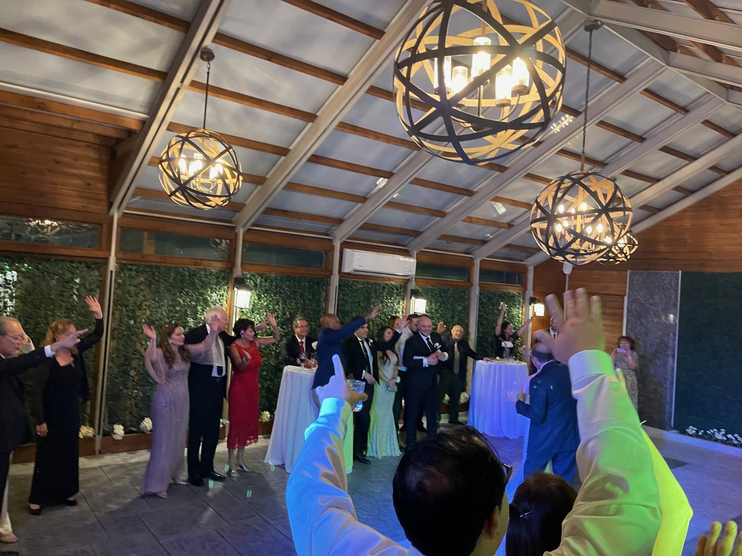 The couple dancing surrounded by their guests