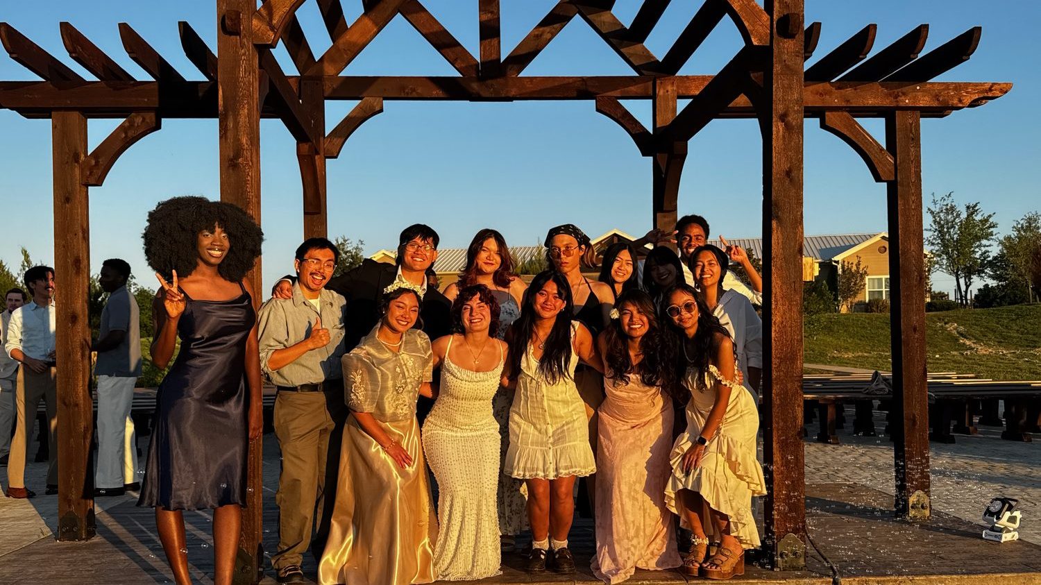 A wedding party celebrating at golden hour