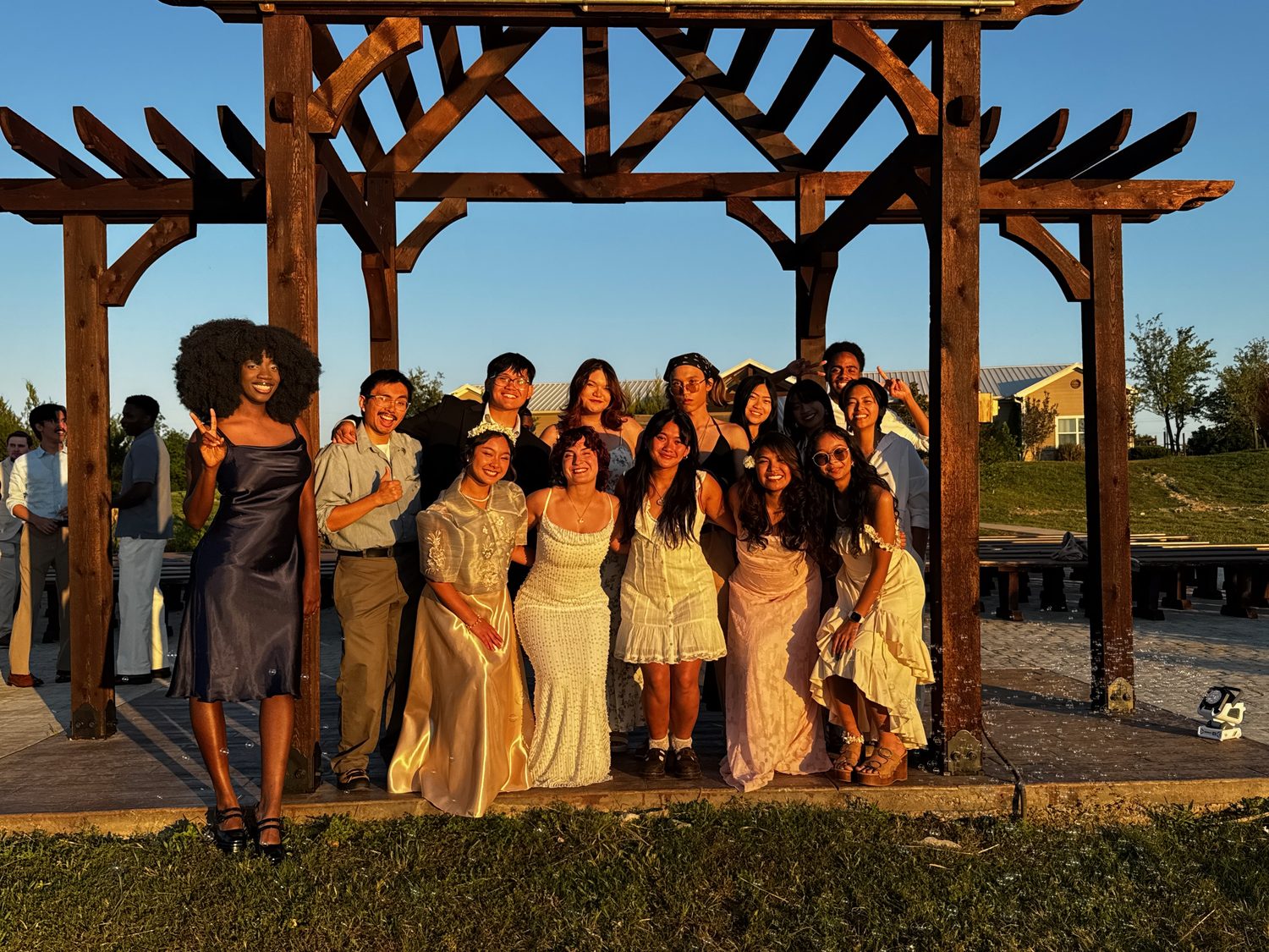 A wedding party celebrating at golden hour